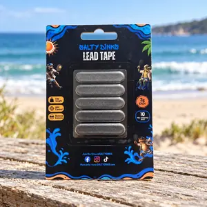 Salty Dinks lead tape paddle weights pack standing on a driftwood log at the beach